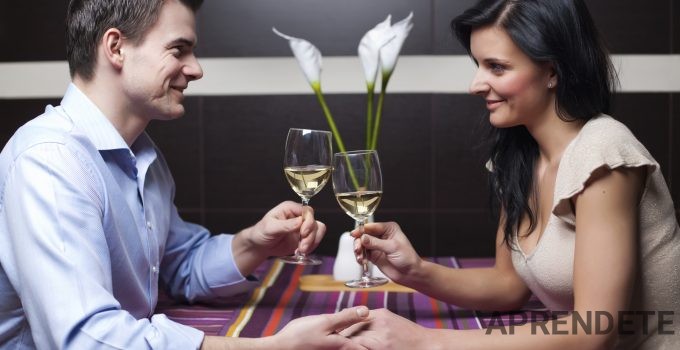 Young couple drinking wine and flirting